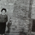 Mme Lascoux in front of the chimney of the wood oven in 1955